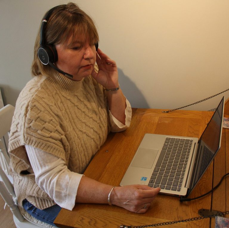 Natalie sitting at desk on telephone to client
